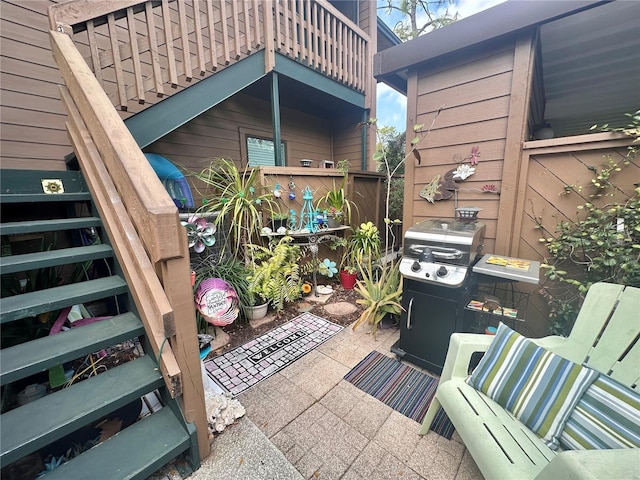 view of patio / terrace featuring a balcony and stairs