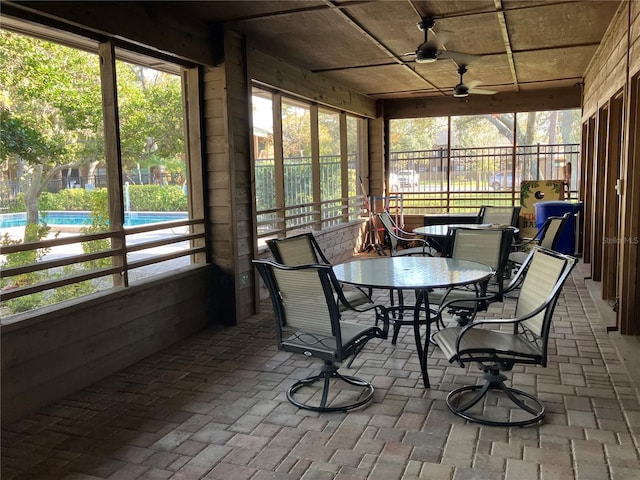 sunroom featuring a ceiling fan