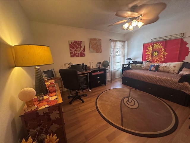 bedroom featuring a ceiling fan and wood finished floors