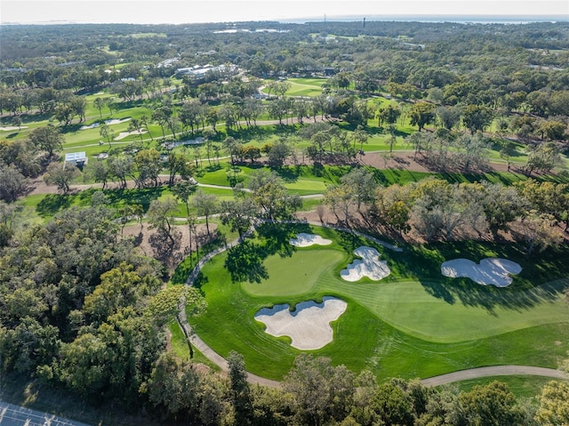 aerial view featuring a wooded view and view of golf course