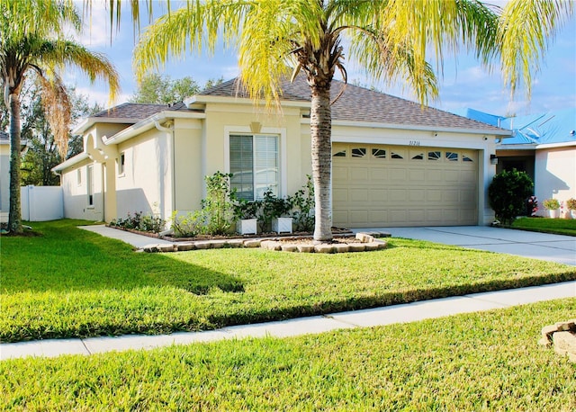 view of front of home featuring a garage and a front yard