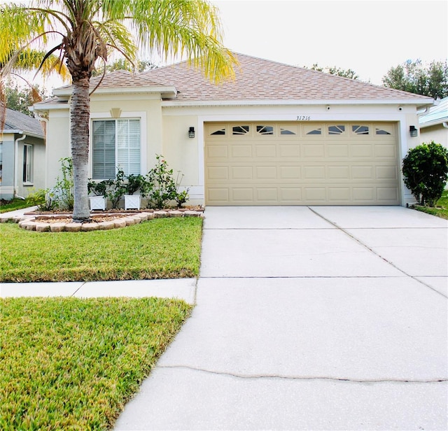 view of front of home featuring a garage and a front lawn