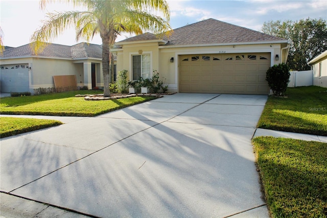 view of front of house featuring a front lawn and a garage