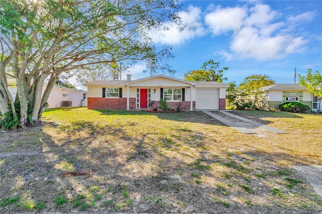 ranch-style house with a front yard, a garage, and central air condition unit