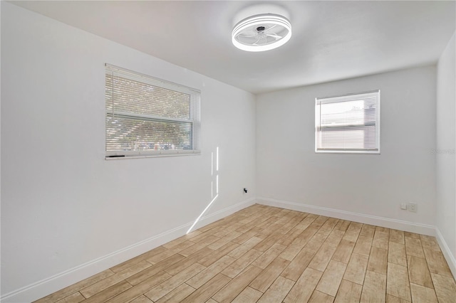 spare room with light hardwood / wood-style flooring