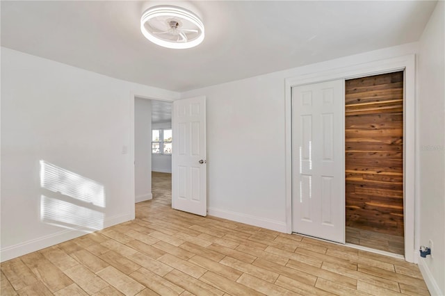 unfurnished bedroom with a closet and light hardwood / wood-style floors