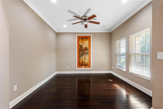 empty room with crown molding, plenty of natural light, dark wood-type flooring, and ceiling fan