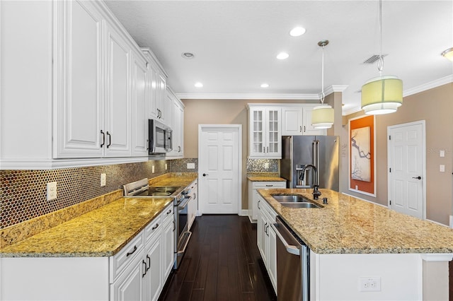 kitchen featuring dark hardwood / wood-style flooring, stainless steel appliances, sink, pendant lighting, and white cabinetry