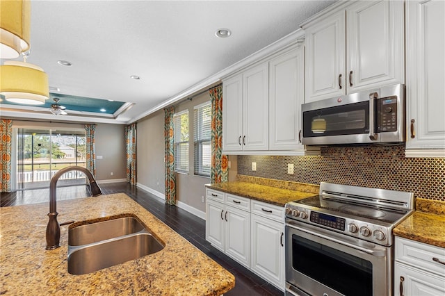 kitchen featuring white cabinets, stainless steel appliances, a healthy amount of sunlight, and sink