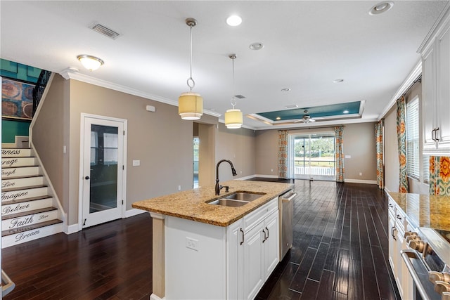 kitchen with white cabinets, appliances with stainless steel finishes, decorative light fixtures, and sink