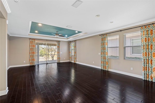 interior space with hardwood / wood-style floors, ceiling fan, a raised ceiling, and crown molding