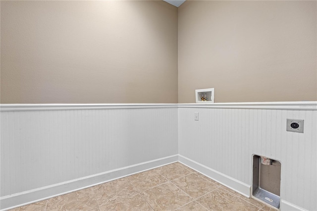 laundry area with electric dryer hookup, hookup for a washing machine, and light tile patterned floors