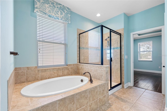 bathroom with tile patterned flooring and shower with separate bathtub