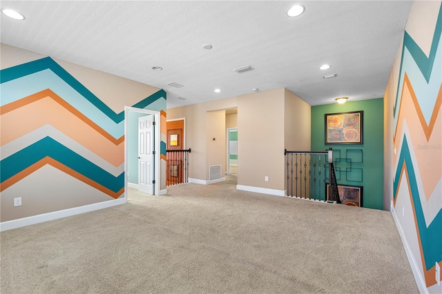 unfurnished living room with carpet floors and a textured ceiling