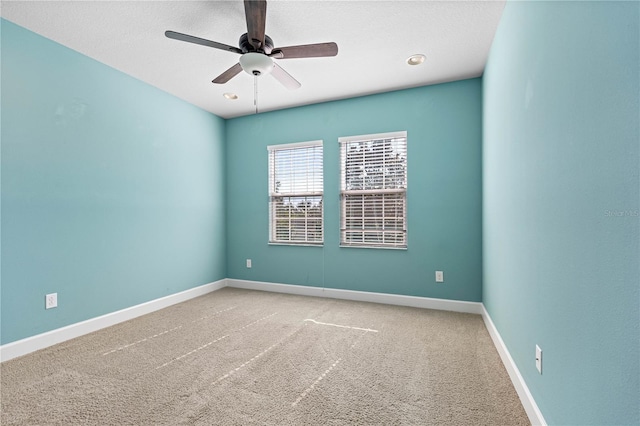 empty room featuring ceiling fan and carpet floors