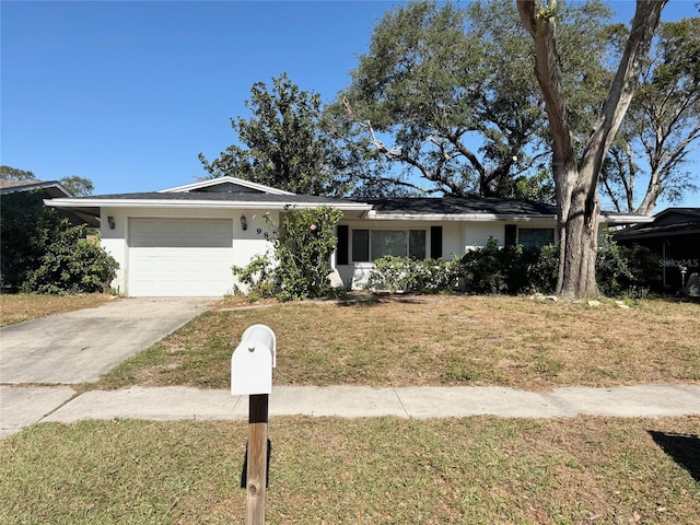 ranch-style home with a front lawn and a garage