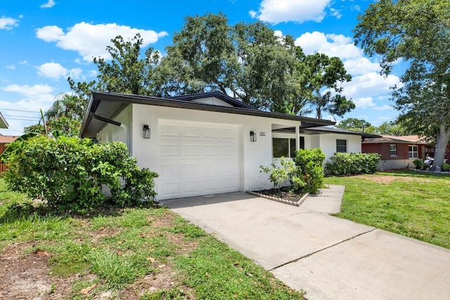 980 5th Ave NE, Largo, FL 33770 - ranch-style house featuring driveway, stucco siding, a garage, and a front lawn