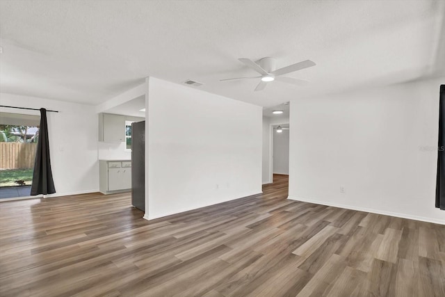 980 5th Ave NE, Largo, FL 33770 - spare room featuring a ceiling fan, wood finished floors, and a textured ceiling