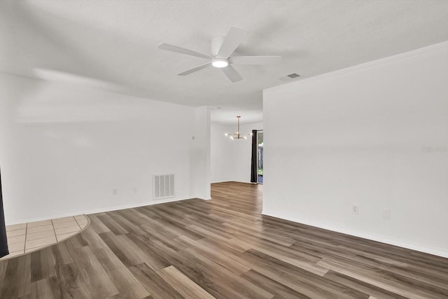 980 5th Ave NE, Largo, FL 33770 - empty room featuring a chandelier, wood finished floors, and ceiling fan