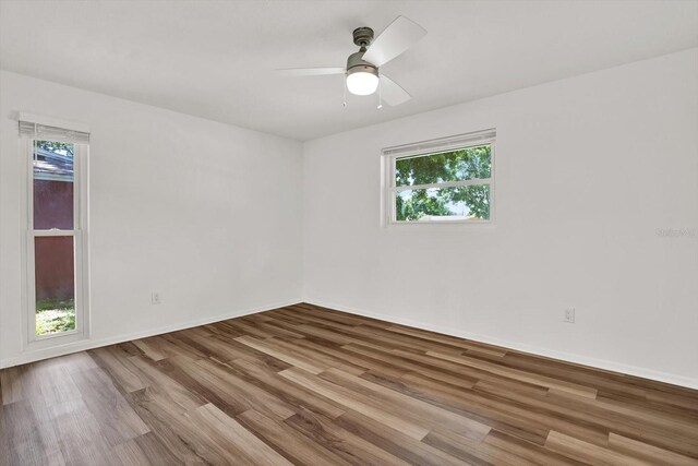 980 5th Ave NE, Largo, FL 33770 - spare room with wood finished floors and ceiling fan