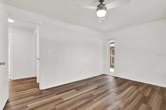 980 5th Ave NE, Largo, FL 33770 - empty room featuring wood finished floors and a ceiling fan