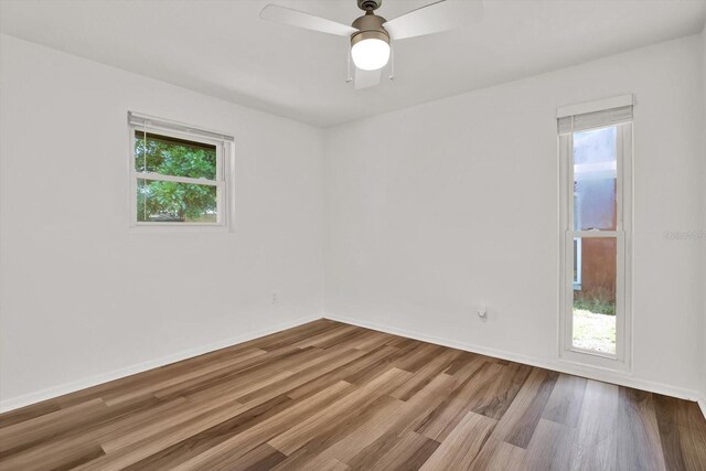 980 5th Ave NE, Largo, FL 33770 - empty room with wood finished floors and a ceiling fan