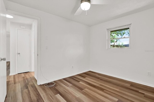 980 5th Ave NE, Largo, FL 33770 - spare room with wood finished floors and ceiling fan