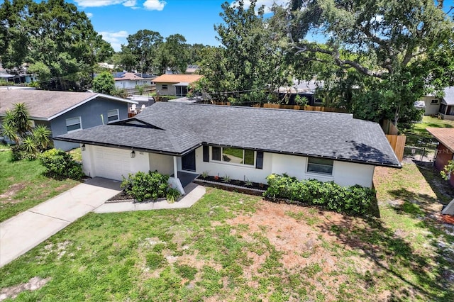 980 5th Ave NE, Largo, FL 33770 - ranch-style home featuring roof with shingles, an attached garage, stucco siding, concrete driveway, and a front yard