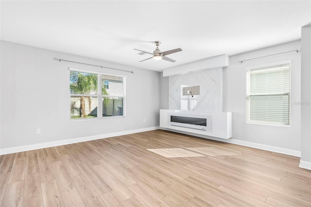 unfurnished living room featuring light hardwood / wood-style floors and ceiling fan