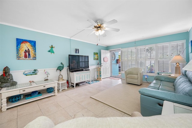 tiled living room with ceiling fan and crown molding