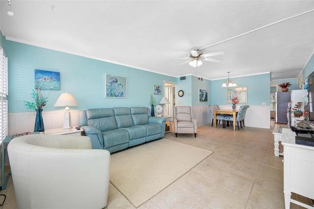 tiled living room featuring ceiling fan with notable chandelier and ornamental molding