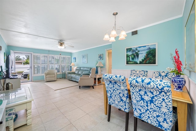 dining space featuring light tile patterned flooring, ceiling fan with notable chandelier, and ornamental molding