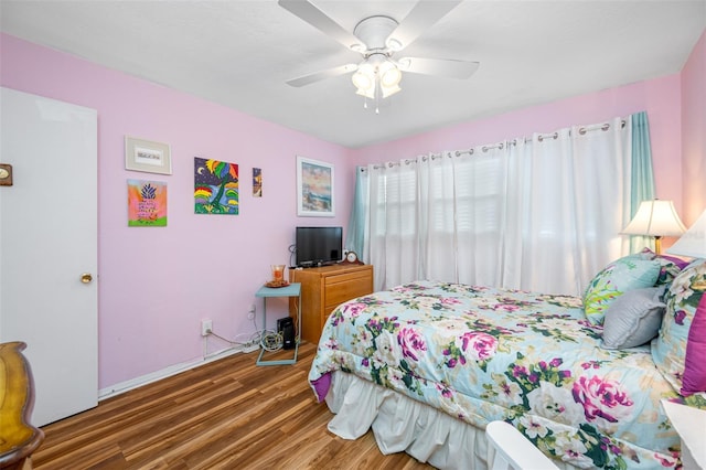 bedroom with ceiling fan and dark hardwood / wood-style floors