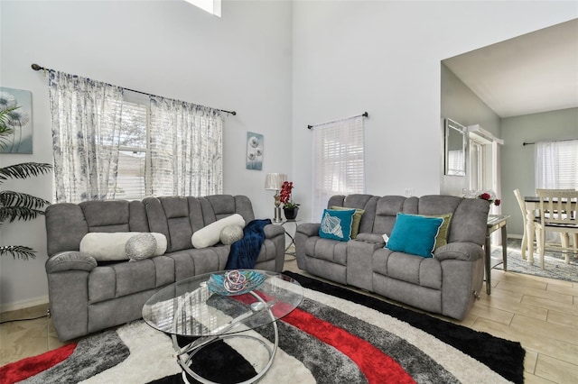 living room with high vaulted ceiling