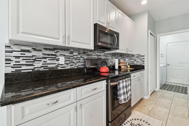 kitchen featuring white cabinetry, black / electric stove, and dark stone counters