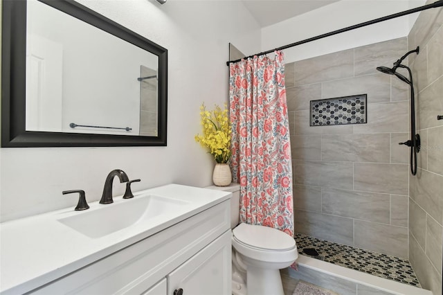 bathroom featuring a shower with curtain, vanity, and toilet