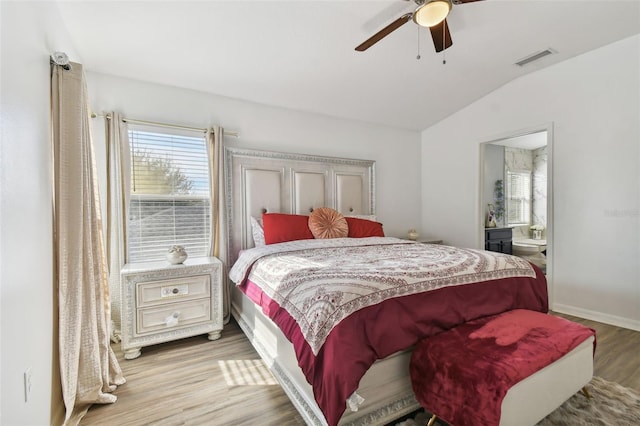 bedroom with ceiling fan, light hardwood / wood-style floors, and lofted ceiling