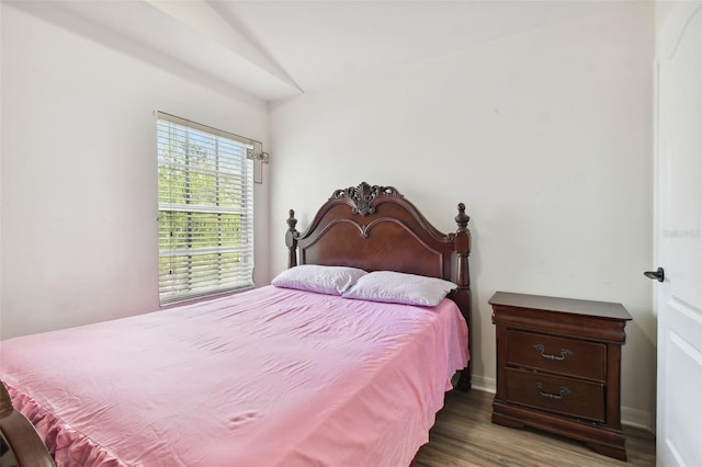 bedroom with dark hardwood / wood-style flooring