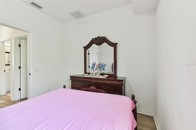 bedroom with wood-type flooring