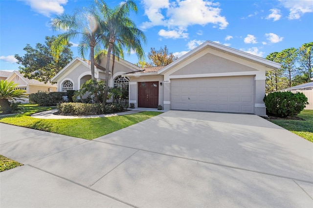 ranch-style house featuring a front yard and a garage