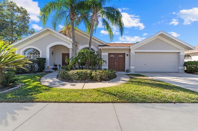 ranch-style home featuring a front yard and a garage