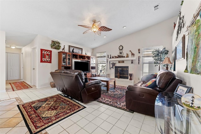 tiled living room featuring ceiling fan and vaulted ceiling