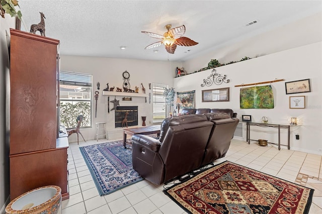 living room featuring lofted ceiling, light tile patterned floors, and a textured ceiling