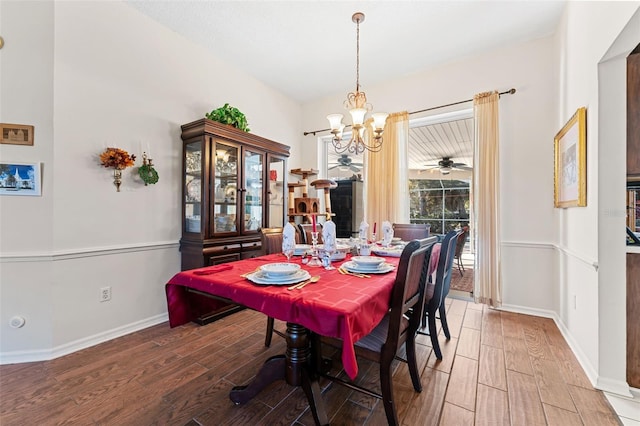 dining area featuring ceiling fan with notable chandelier and hardwood / wood-style flooring