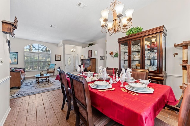 dining room featuring a notable chandelier and wood-type flooring