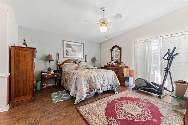 bedroom featuring a textured ceiling, ceiling fan, wood-type flooring, and lofted ceiling