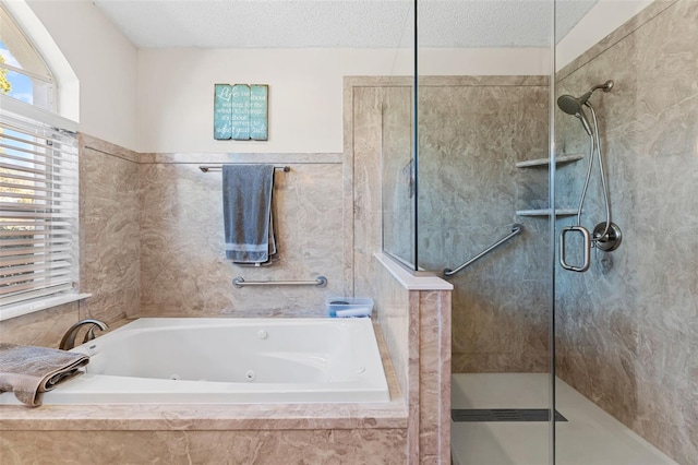 bathroom featuring plus walk in shower and a textured ceiling