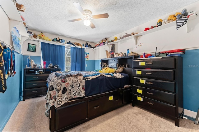 bedroom featuring ceiling fan, light colored carpet, and a textured ceiling