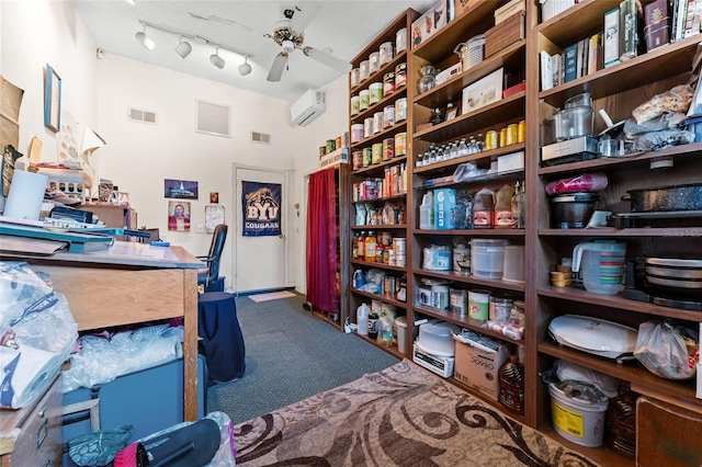 office area featuring a wall unit AC, ceiling fan, carpet flooring, and rail lighting