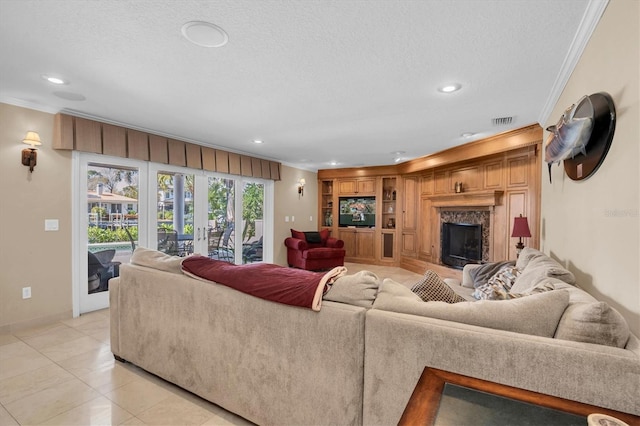 living room with crown molding, a fireplace, french doors, and a textured ceiling